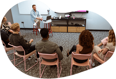 Tom Lavery coaching a group of salespeople sat in a circle in 2021